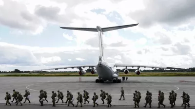 Russian paratroopers walk before boarding Ilyushin Il-76 transport planes as they take part in the military exercises "Zapad-2021" staged by the armed forces of Russia and Belarus at an aerodrome in Kaliningrad Region, Russia, September 13, 2021. REUTERS/Vitaly Nevar