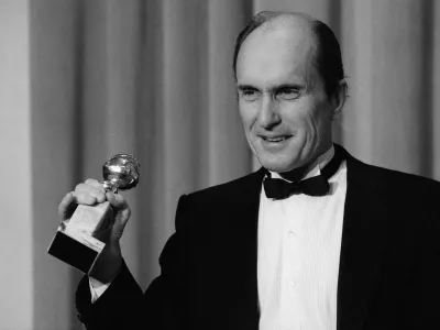 FILE - Actor Robert Duvall holds the Golden Globe award he won for best actor in a dramatic motion picture for his role in "Tender Mercies" in Beverly Hills, Calif., on Jan. 29,198 4. (AP Photo/Lennox Mclendon, File)
