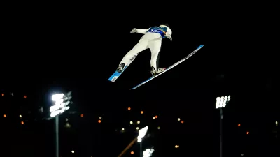 Domen Prevc, of Slovenia, soars through the air during his first round jump of the ski jumping men's super team competition at the 2026 Winter Olympics, in Predazzo, Italy, Monday, Feb. 16, 2026. (AP Photo/Matthias Schrader)