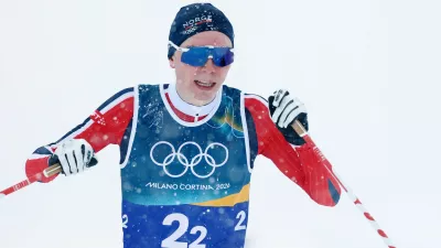 Milano Cortina 2026 Olympics - Nordic Combined - Team Sprint, Cross-Country - Tesero Cross-Country Skiing Stadium, Lago, Italy - February 19, 2026. Jens Luraas Oftebro of Norway celebrates as he crosses the finish line to win gold REUTERS/Kai Pfaffenbach
