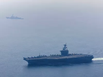 The U.S. Navy's Nimitz-class aircraft carrier USS Abraham Lincoln and Arleigh Burke-class guided-missile destroyer USS Frank E. Petersen Jr. sail during a photo exercise in the Arabian Sea, February 6, 2026. U.S. Navy/Mass Communication Specialist 1st Class Jesse Monford/Handout via REUTERS THIS IMAGE HAS BEEN SUPPLIED BY A THIRD PARTY