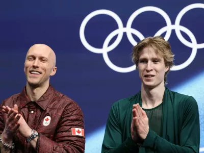 Milano Cortina 2026 Olympics - Figure Skating - Men Single Skating - Free Skating - Milano Ice Skating Arena, Milan, Italy - February 13, 2026. Stephen Gogolev of Canada with his coach Benoit Richaud after his performance during the Free Skating REUTERS/Yara Nardi