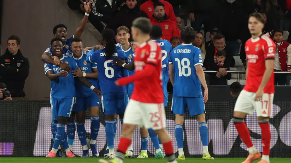 Real Madrid's Vinicius Junior celebrates with team mates the opening goal during a Champions League playoff soccer match between SL Benfica and Real Madrid in Lisbon, Portugal, Tuesday, Feb. 17, 2026. (AP Photo/Pedro Rocha)