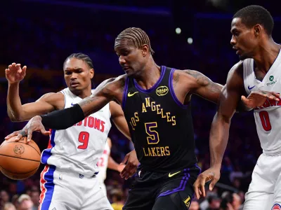 Dec 30, 2025; Los Angeles, California, USA; Los Angeles Lakers center Deandre Ayton (5) plays for the ball against Detroit Pistons guard Ausar Thompson (9) and center Jalen Duren (0) during the first half at Crypto.com Arena. Mandatory Credit: Gary A. Vasquez-Imagn Images