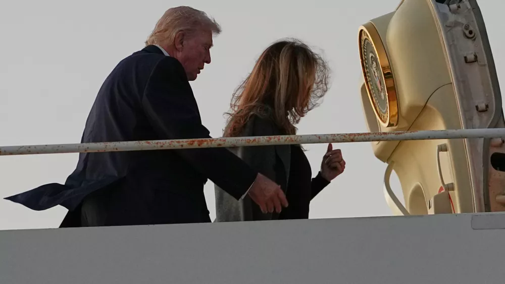 President Donald Trump and first lady Melania Trump board Air Force One at Palm Beach International Airport in West Palm Beach, Fla., Monday, Feb. 16, 2026. (AP Photo/Matt Rourke)