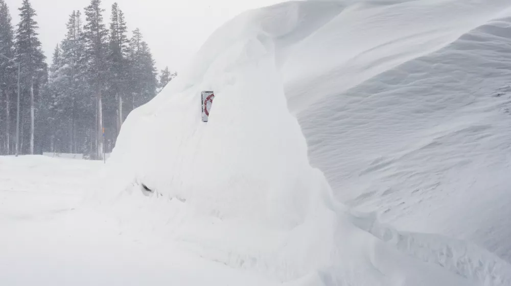 Snow piles up along a road on Wednesday, Feb. 18, 2026 near Soda Springs, Calif. (AP Photo/Brooke Hess-Homeier)