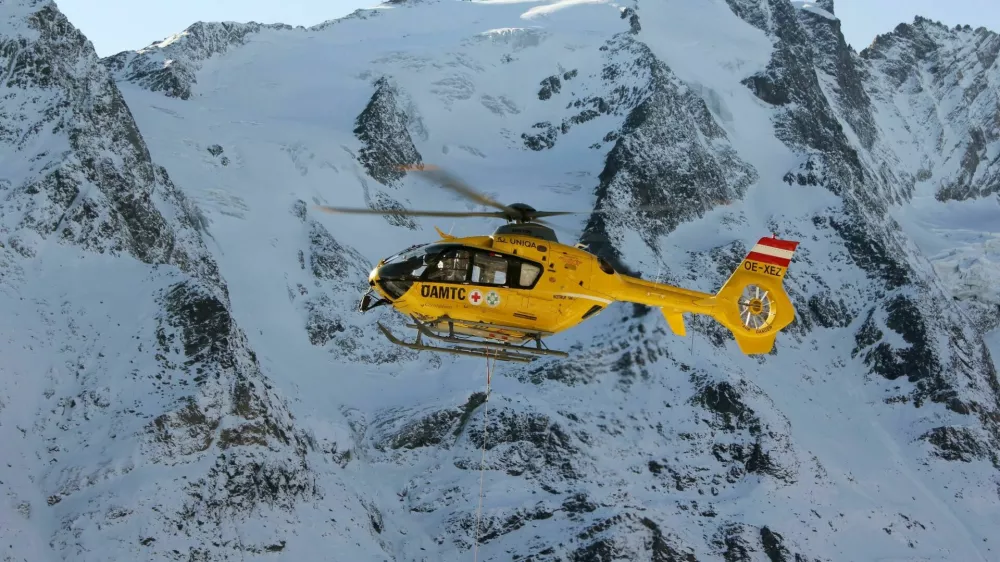 "Grossglockner, Austria - October 30, 2011: Rescue helicopter from Austrian Mountain Rescue Service flying at accident site at October 30, 2011. At 2001 Rescue Service performed a total of 6508 rescues."
