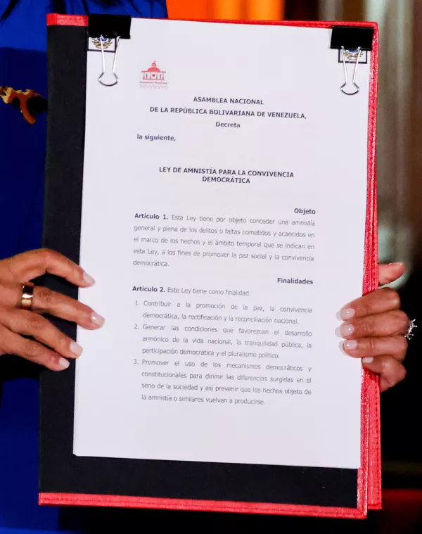 Venezuela's interim President Delcy Rodriguez holds the text of the amnesty law meant to grant immediate clemency to individuals jailed for participating in political protests following its approval, at Miraflores Palace, in Caracas, Venezuela, February 19, 2026. REUTERS/Leonardo Fernandez Viloria
