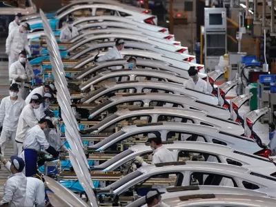 Employees work on a production line inside a Dongfeng Honda factory after lockdown measures in Wuhan, the capital of Hubei province and China's epicentre of the novel coronavirus disease (COVID-19) outbreak, were further eased, April 8, 2020. REUTERS/Aly Song