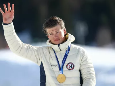 Milano Cortina 2026 Olympics - Cross-Country Skiing - Men's 10km + 10km Skiathlon Victory Ceremony - Tesero Cross-Country Skiing Stadium, Lago, Italy - February 08, 2026. Gold medallist Johannes Hoesflot Klaebo of Norway celebrates on the podium after winning the Men's 10km + 10km Skiathlon REUTERS/Kai Pfaffenbach