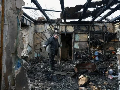 A resident removes debris from his house, which was hit by a Russian drone strike, amid Russia's attack on Ukraine, in Odesa, Ukraine February 21, 2026. REUTERS/Nina Liashonok   TPX IMAGES OF THE DAY