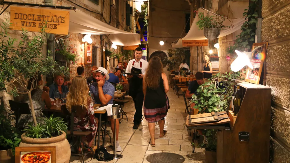 Pedestrians and customers enjoying the restaurants and nightlife of Split in Croatia