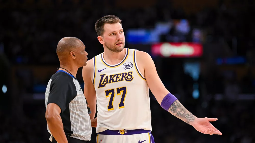 Los Angeles Lakers guard Luka Doncic speaks to referee Michael Smith during the first half of an NBA basketball game against the Boston Celtics, Sunday, Feb. 22, 2026, in Los Angeles. (AP Photo/Katie Chin)