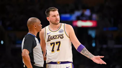 Los Angeles Lakers guard Luka Doncic speaks to referee Michael Smith during the first half of an NBA basketball game against the Boston Celtics, Sunday, Feb. 22, 2026, in Los Angeles. (AP Photo/Katie Chin)