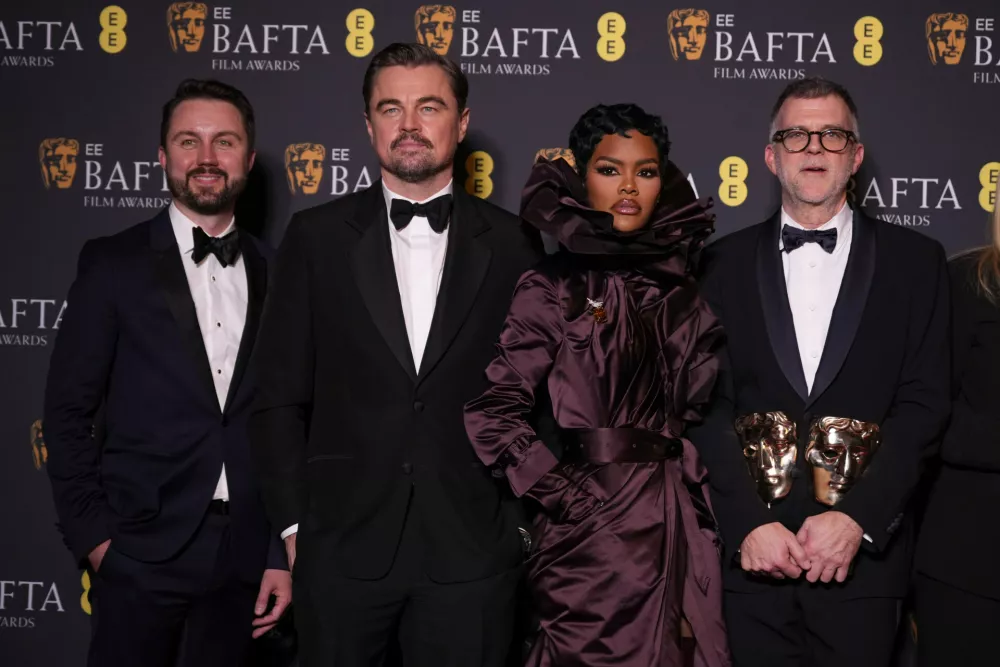 Andy Jurgensen, from left, Leonardo DiCaprio, Teyana Taylor, and Paul Thomas Anderson pose with the awards for best director, cinematography, and adapted screenplay for 'One Battle After Another' at the 79th British Academy Film Awards, BAFTA's, in London, Sunday, Feb. 22, 2026. (AP Photo/Alastair Grant)