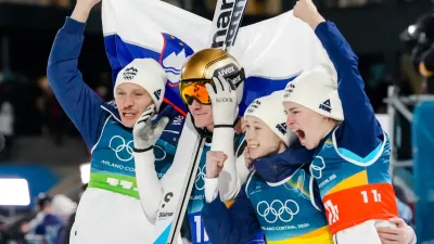 Nika Vodan, from right, Nika Prevc, Domen Prevc, and Anze Lanisek, of Slovenia, celebrate after winning the gold medal in the ski jumping mixed team competition at the 2026 Winter Olympics, in Predazzo, Italy, Tuesday, Feb. 10, 2026. (AP Photo/Evgeniy Maloletka)