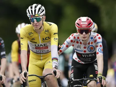 Cycling - Tour de France - Stage 20 - Nantua to Pontarlier - Pontarlier, France - July 26, 2025 UAE Team Emirates XRG's Tadej Pogacar and Team Visma | Lease a Bike's Jonas Vingegaard cross the finish line after stage 20 REUTERS/Benoit Tessier