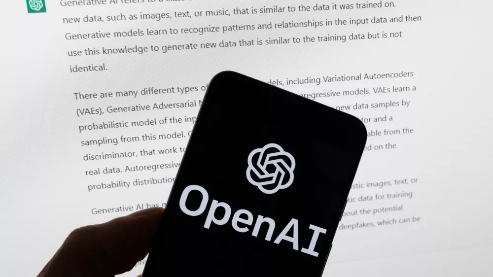 FILE - The OpenAI logo is displayed on a mobile phone in front of a computer screen with output from ChatGPT, March 21, 2023, in Boston. (AP Photo/Michael Dwyer, File)