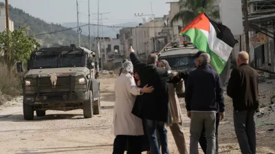 Displaced Palestinians gather during a protest calling to return to their houses in the Nur Shams refugee camp, in the West Bank city of Tulkarem, Monday, Dec. 15, 2025. (AP Photo/Majdi Mohammed)