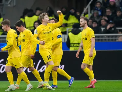 Glimt's Jens Petter Hauge, center, celebrates with team mates after scoring his side's first goal during a Champions League playoff soccer match between Inter Milan and Bodo Glimt, at the San Siro stadium in Milan, Italy, Tuesday, Feb.24, 2026. (AP Photo/Luca Bruno)