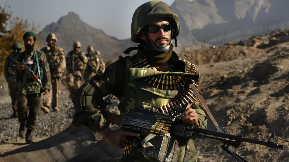 Soldiers from the Afghan National Army, and Canadian soldiers from 3rd Bat, Royal 22nd Regiment of Valcartier, Quebec return from a patrol in the town of Panjwayi in the Kandahar province of Afghanistan Thursday, Nov. 23, 2006. (AP Photo/David Guttenfelder)