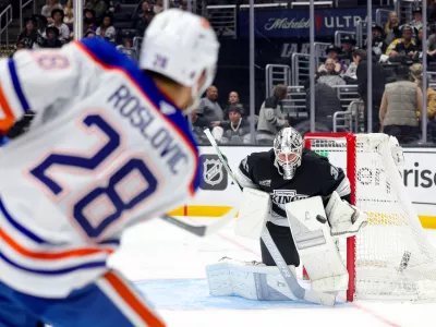 Edmonton Oilers center Jack Roslovic, left, shoots against Los Angeles Kings goaltender Anton Forsberg during the third period of an NHL hockey game Thursday, Feb. 26, 2026 in Los Angeles. (AP Photo/Ryan Sun)