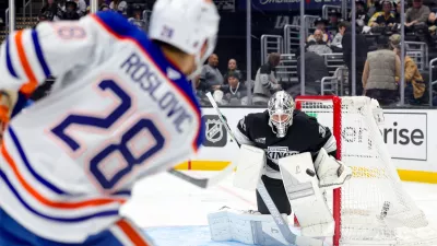 Edmonton Oilers center Jack Roslovic, left, shoots against Los Angeles Kings goaltender Anton Forsberg during the third period of an NHL hockey game Thursday, Feb. 26, 2026 in Los Angeles. (AP Photo/Ryan Sun)