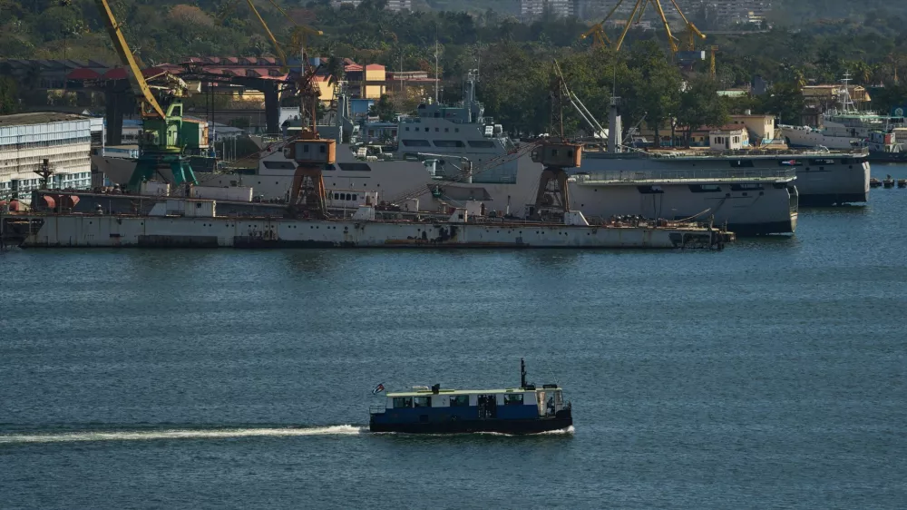 A ferry boat navigates across Havana Bay as it passes Cuban coast guard ships docked at the port as it leaves Casablanca, Cuba, Thursday, Feb. 26, 2026. (AP Photo/Ramon Espinosa)