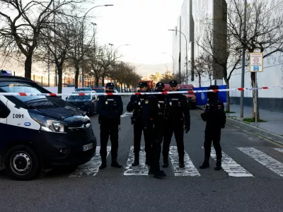 Spanish police officers stand behind a security cordon near the City of Justice building, which is being used as a morgue, following the deadly derailment of two high-speed trains near Adamuz, in Cordoba, Spain, January 20, 2026. REUTERS/Jon Nazca