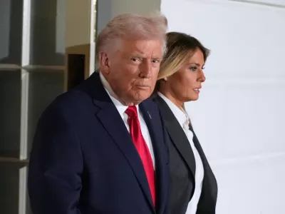 President Donald Trump and first lady Melania Trump, walk out of the White House, Tuesday, Feb. 24, 2026, to travel to the U.S. Capitol where he will deliver the State of the Union address to a joint session of Congress in the House chamber, in Washington. (AP Photo/Manuel Balce Ceneta)
