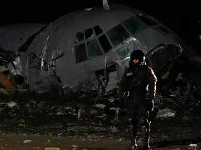 A military police stands next to a plane that crashed in El Alto, Bolivia, Friday, Feb. 27, 2026. (AP Photo/Juan Karita)