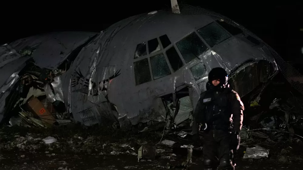 A military police stands next to a plane that crashed in El Alto, Bolivia, Friday, Feb. 27, 2026. (AP Photo/Juan Karita)