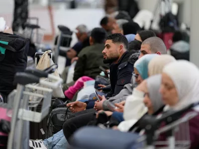 Passengers whose flights were cancelled, wait at the departure terminal of Rafik Hariri International Airport in Beirut, Lebanon, Saturday, Feb. 28, 2026, as many airlines canceled flights due to the conflict involving the United States, Israel and Iran. (AP Photo/Hassan Ammar)