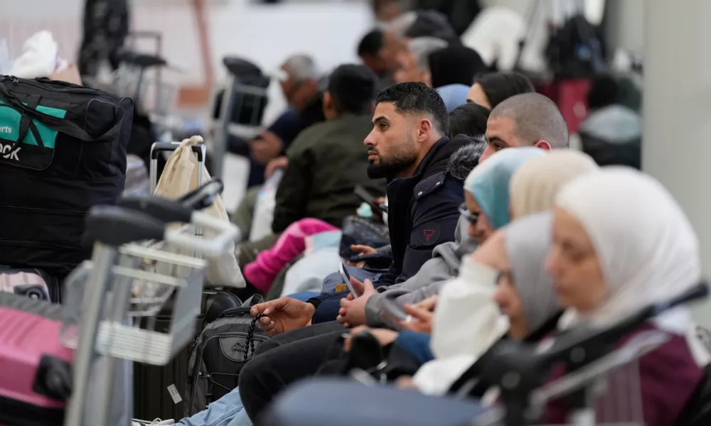 Passengers whose flights were cancelled, wait at the departure terminal of Rafik Hariri International Airport in Beirut, Lebanon, Saturday, Feb. 28, 2026, as many airlines canceled flights due to the conflict involving the United States, Israel and Iran. (AP Photo/Hassan Ammar)