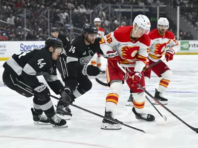 Feb 28, 2026; Los Angeles, California, USA; Calgary Flames right wing Matvei Gridin (92) battles for the puck during the third period against the Los Angeles Kings at Crypto.com Arena. Mandatory Credit: Griffin Hooper-Imagn Images