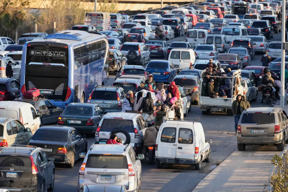Displaced people fleeing Israeli strikes in southern Lebanon sit in traffic at a highway links to Beirut, in the southern port city of Sidon, Monday, March 2, 2026. (AP Photo/Mohammed Zaatari)