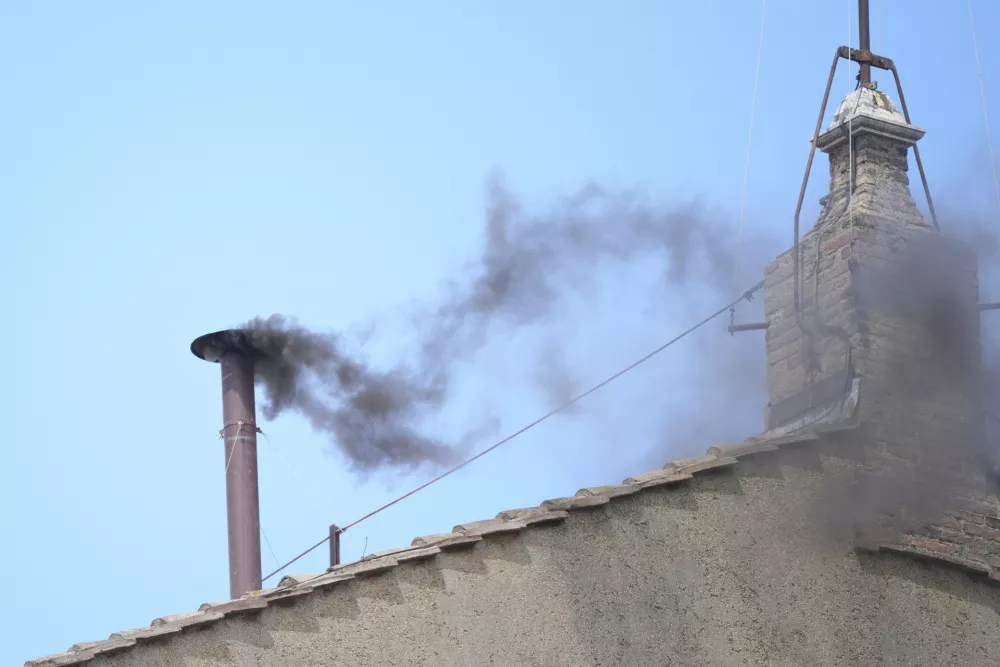 Black smoke billows from the chimney of the Sistine Chapel during the conclave to elect a new pope, at the Vatican, Thursday, May 8, 2025. (AP Photo/Andrew Medichini)