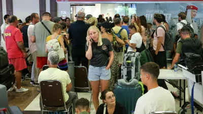 Stranded passengers wait near Emirates Airways customer service office at I Gusti Ngurah Rai International Airport after flights to Doha, Dubai, and Abu Dhabi were cancelled following strikes on Iran launched by the United States and Israel, in Kuta, Bali, Indonesia, March 1, 2026. REUTERS/Johannes Christo