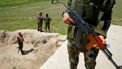 Yazidi female fighter Asema Dahir (R), 21, holds a weapon during a deployment near the frontline of the fight against Islamic State militants in Nawaran near Mosul, Iraq, April 20, 2016. When Islamic State swept into the northern Iraqi town of Sinjar in 2014, a few young Yazidi women took up arms against the militants attacking women and girls from their community. The killing and enslaving of thousands from Iraq's minority Yazidi community focused international attention on the group's violent campaign to impose its radical ideology and prompted Washington to launch an air offensive. It also prompted the formation of this unusual 30-woman unit made up of Yazidis as well as Kurds from Iraq and neighbouring Syria. For them, only one thing matters: revenge for the women raped, beaten and executed by the jihadist militants. REUTERS/Ahmed Jadallah SEARCH "WOMEN NAWARAN" FOR THIS STORY. SEARCH "THE WIDER IMAGE" FOR ALL STORIES