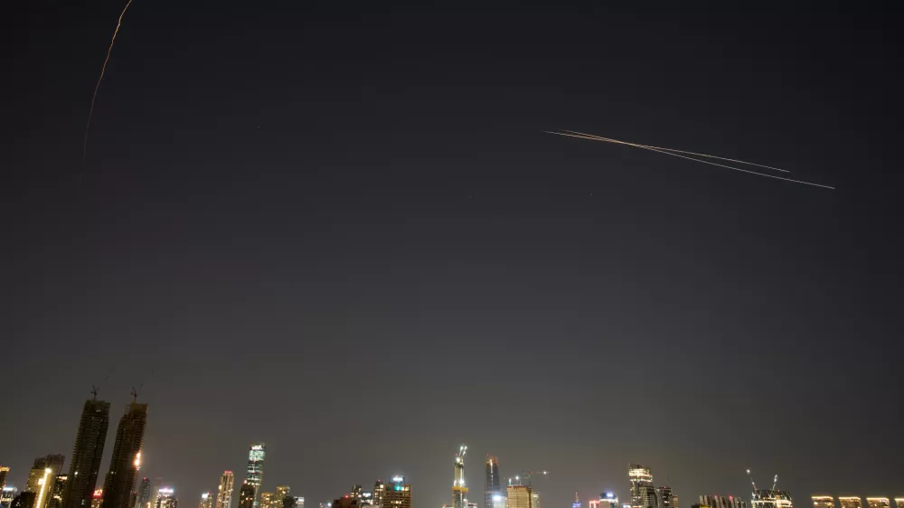 Israeli air defense system fires to intercept missiles during an Iranian attack over Tel Aviv, Israel, early Tuesday, March 3, 2026. (AP Photo/Ohad Zwigenberg)