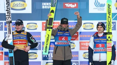 Ski Jumping - Four Hills Tournament - Innsbruck, Austria - January 4, 2026 Japan's Ren Nikaido celebrates on the podium after winning the Men's Individual HS128 alongside second place Slovenia's Domen Prevc and third place Austria's Stephan Embacher REUTERS/Kai Pfaffenbach