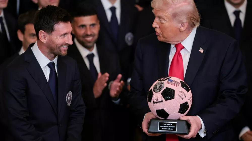 U.S. President Donald Trump is gifted a jewelled soccer ball with his signature on it from Inter Miami CF captain Lionel Messi, on the day he honors reigning Major League Soccer (MLS) champion Inter Miami CF players and team officials with an event in the East Room of the White House in Washington, D.C., U.S., March 5, 2026. REUTERS/Jonathan Ernst