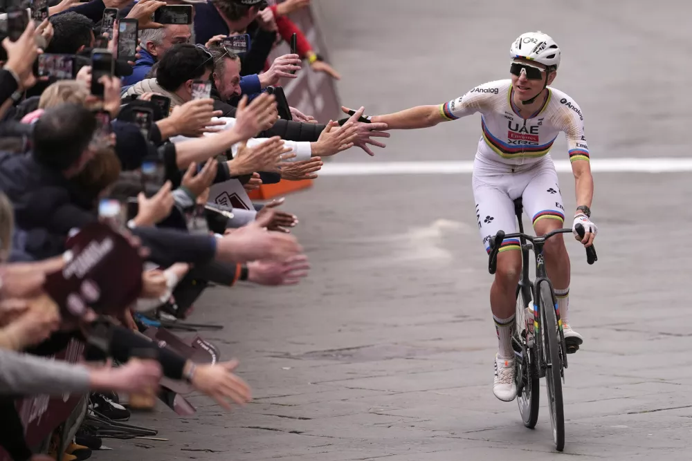 Tadej Pogacar of Team UAE Emirates celebrates winning the Strade Bianche (White Roads), a 203 km one day cycling race from and to Siena, Italy, Saturday March 7, 2026. (Fabio Ferrari/LaPresse via AP)