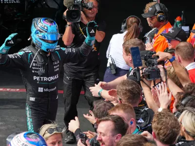 Mercedes driver George Russell of Britain celebrates to his team after winning the Australian Formula One Grand Prix at Albert Park, in Melbourne, Australia, Sunday, March 8, 2026. (AP Photo/Scott Barbour)