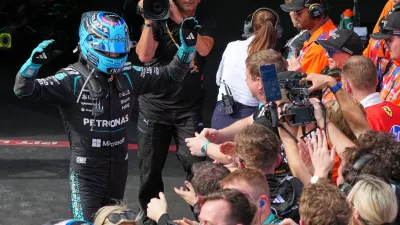 Mercedes driver George Russell of Britain celebrates to his team after winning the Australian Formula One Grand Prix at Albert Park, in Melbourne, Australia, Sunday, March 8, 2026. (AP Photo/Scott Barbour)