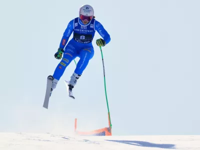 Italy's Elena Curtoni is airborne during an alpine ski, women's World Cup super-G, in Val di Fassa, Italy, Sunday, March 8, 2026. (AP Photo/Luciano Bisi)