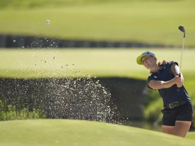 Pia Babnik, of Slovenia, plays out of a bunker on the 18th green during the final round of the women's golf event at the 2024 Summer Olympics, Saturday, Aug. 10, 2024, at Le Golf National, in Saint-Quentin-en-Yvelines, France. (AP Photo/Matt York)
