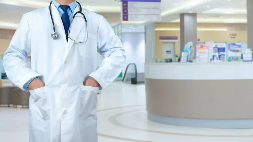 Smart doctor with a stethoscope around his neck on the hospital blurred background, Healthcare medical technology concept, copy space, Color effect tone, Copy space for text.,Image: 922087993, License: Royalty-free, Restrictions:, Model Release: yes