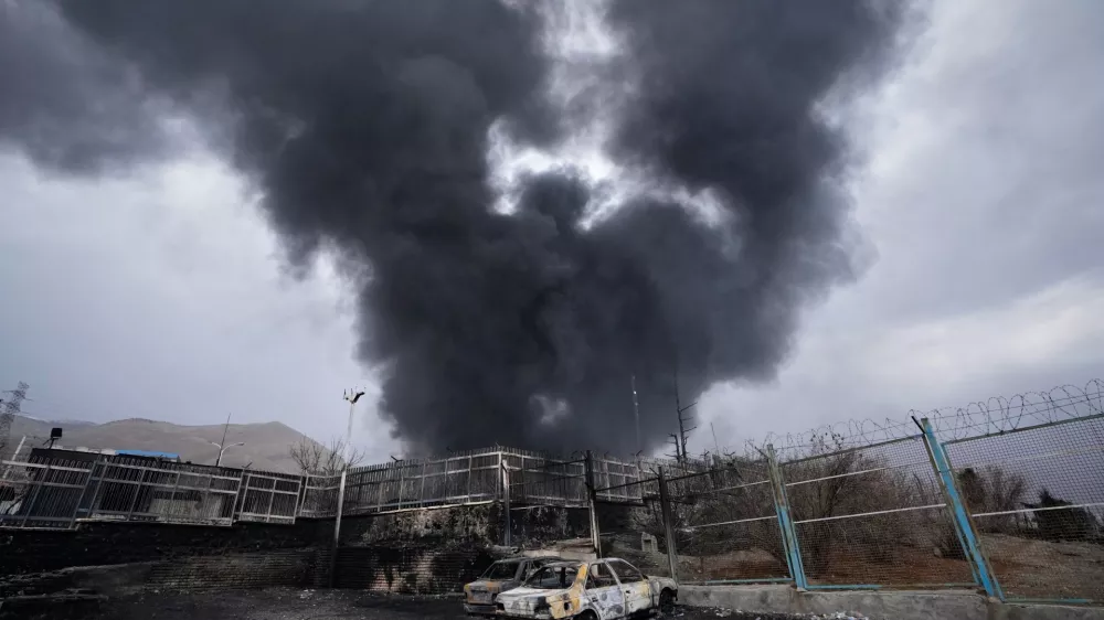 FILE - A thick plume of smoke rises from an oil storage facility hit by a U.S.-Israeli strike in Tehran, Iran, March 8, 2026. (AP Photo/Vahid Salemi, file)
