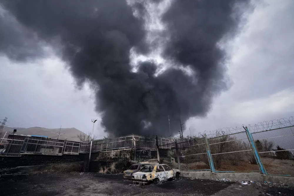 FILE - A thick plume of smoke rises from an oil storage facility hit by a U.S.-Israeli strike in Tehran, Iran, March 8, 2026. (AP Photo/Vahid Salemi, file)